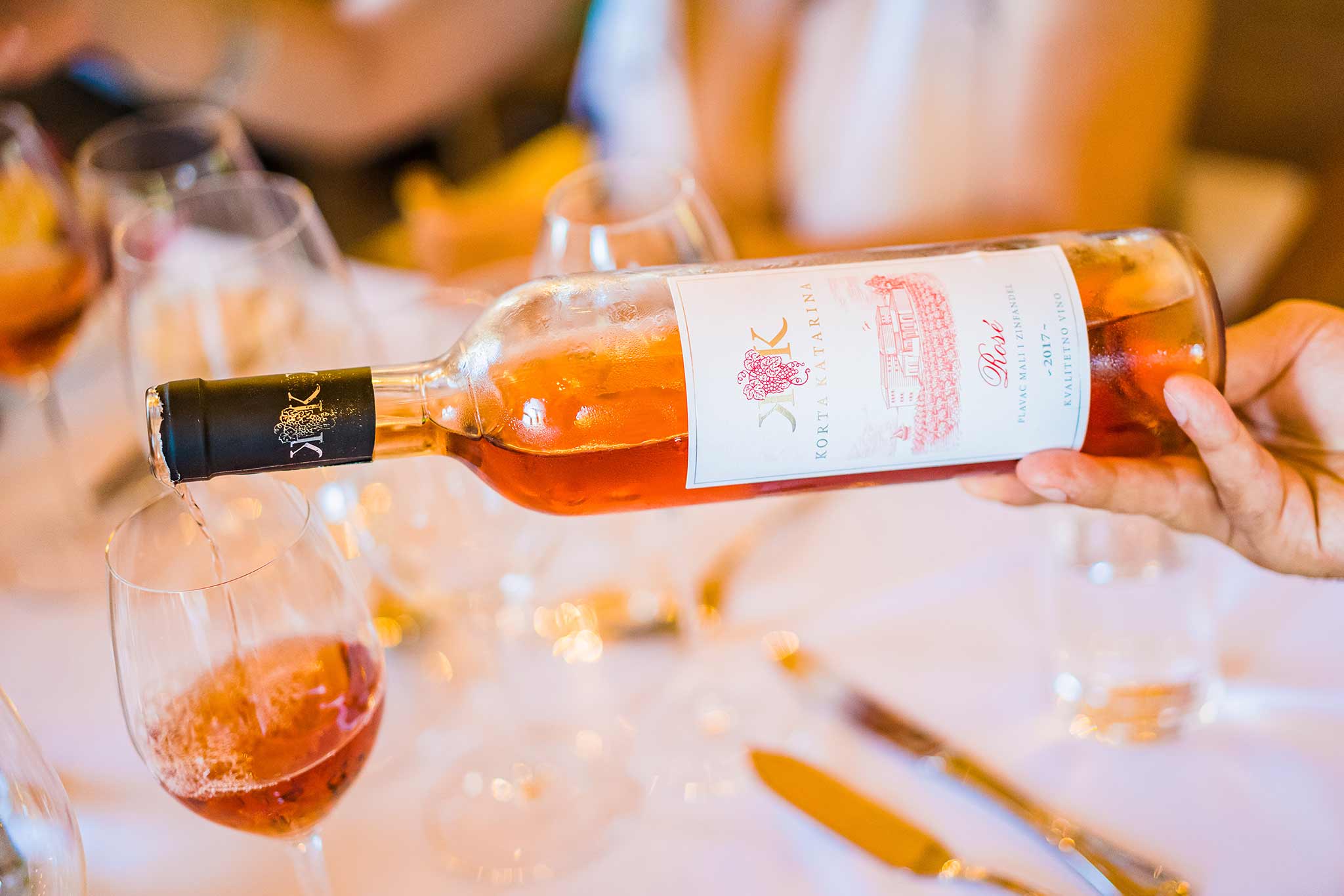 pouring rose into a glass